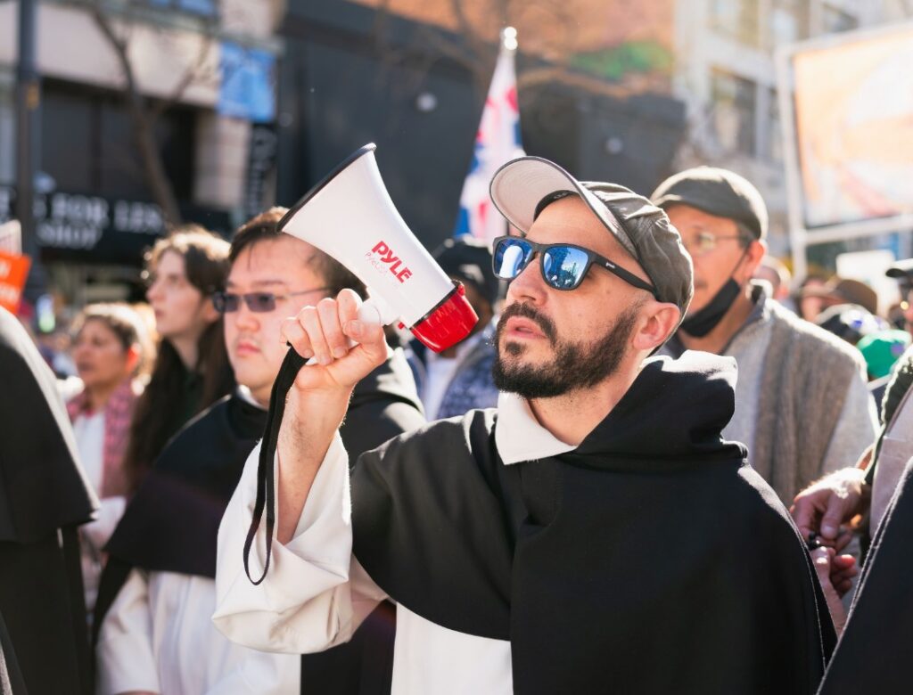 Group walking through the streets with signs and megaphones